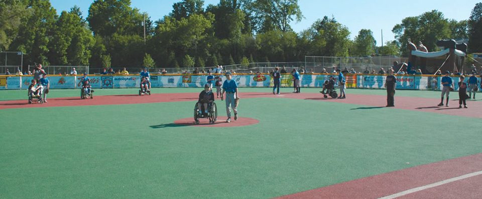 Kids at play on Miracle League baseball field.