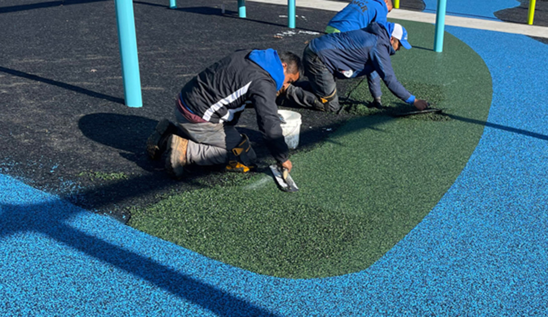 two contractors installing new pour in place rubber surfacing